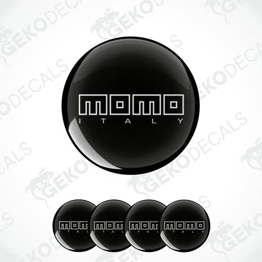 A set of black vinyl decals with the text 'momo ITALY' in white. The decals are dome-shaped and designed for use as car wheel or cap stickers.