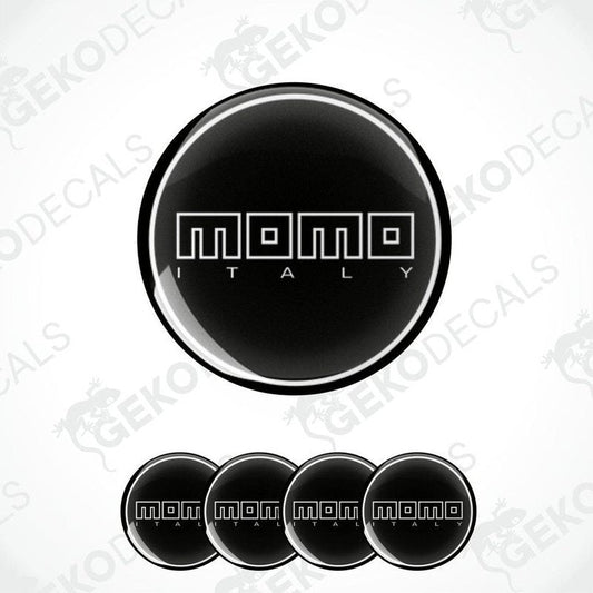 A set of black vinyl decals with the text 'momo ITALY' in white. The decals are designed to be applied on a surface, likely for car customization.