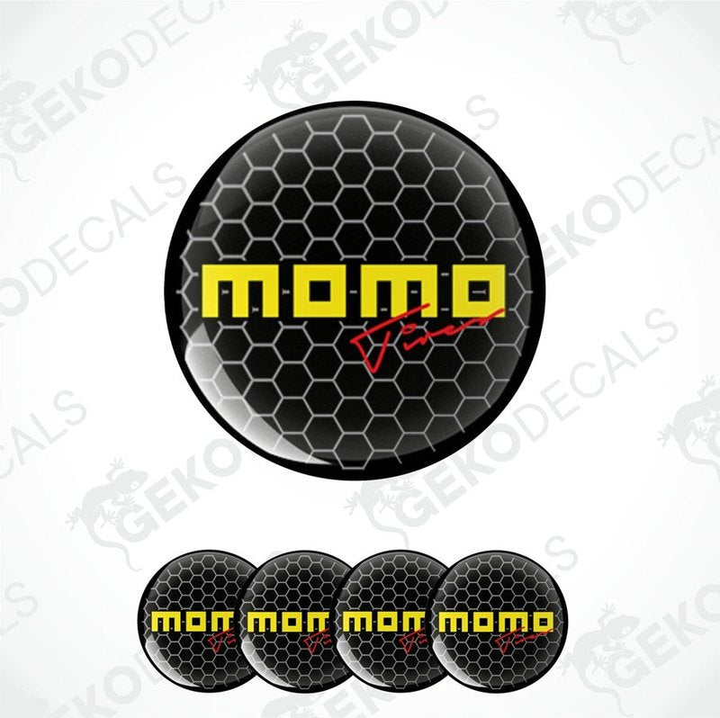 A set of four round black vinyl decals with the text 'momo' in yellow.