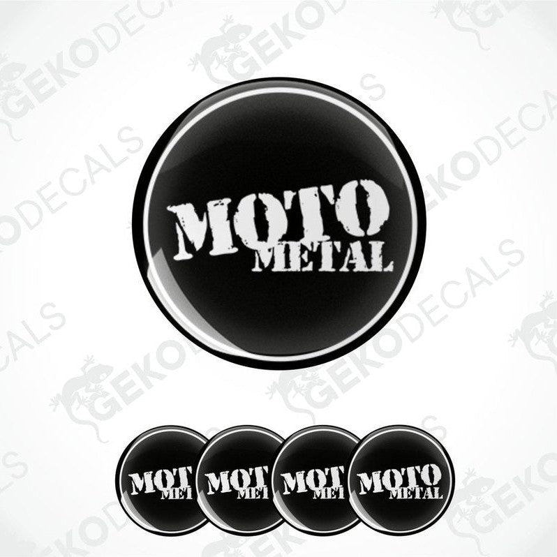 A set of four black and white vinyl decals with the text 'MOTO METAL' on a round, domed sticker design.