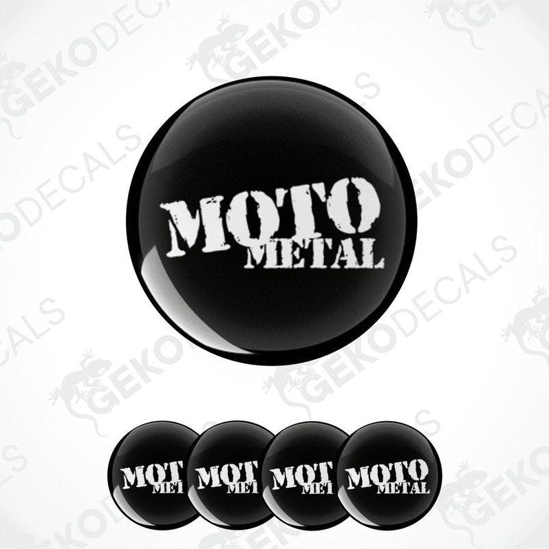 A set of four black vinyl stickers with the text 'MOTO METAL' embossed on them, arranged stacked on top of each other.