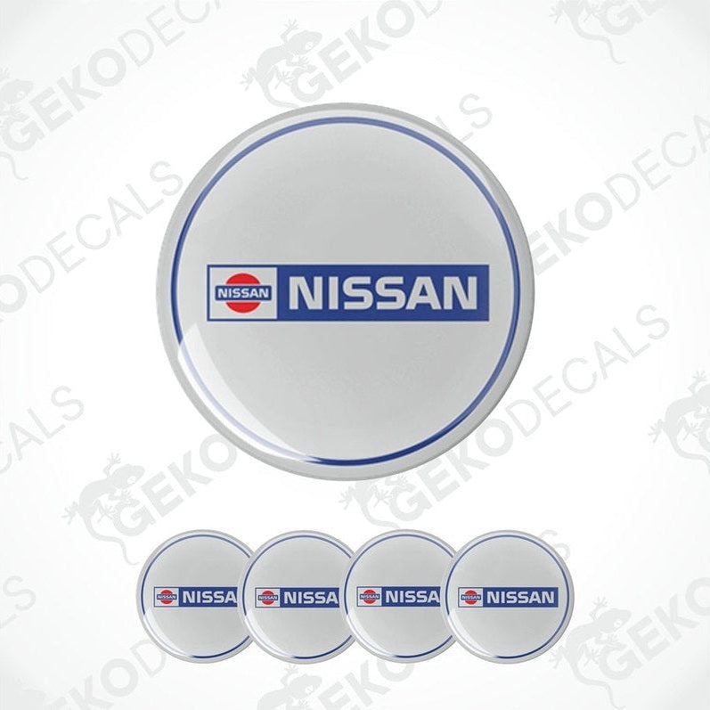A set of four vinyl decals with polyurethane coating, featuring the Nissan logo, presented on a white background.