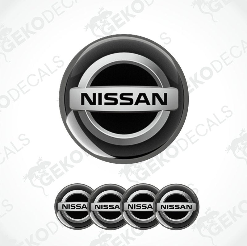 A set of four black vinyl stickers with the NISSAN brand logo on them.