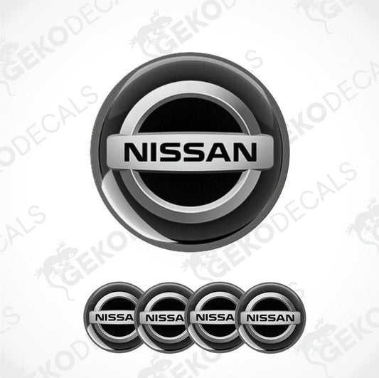A set of four black vinyl stickers with the NISSAN brand logo on them.