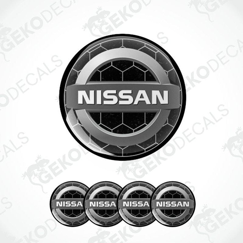 A set of four black vinyl stickers with the NISSAN brand logo on them.