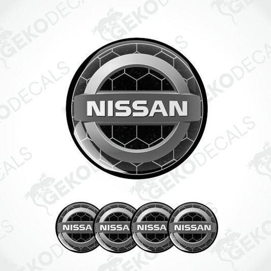 A set of four black vinyl stickers with the NISSAN brand logo on them.