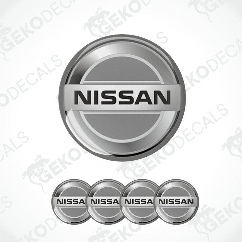 A set of four grey vinyl stickers with the NISSAN brand logo on them.