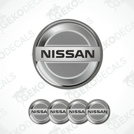 A set of four grey vinyl stickers with the NISSAN brand logo on them.