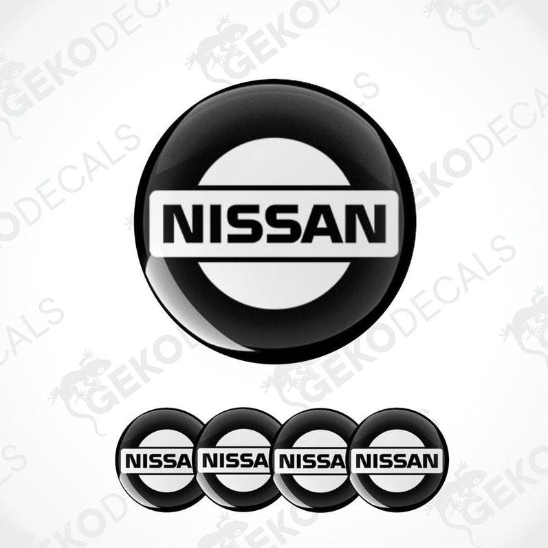 A set of four black, white NISSAN branded vinyl stickers with a polyurethane coating.