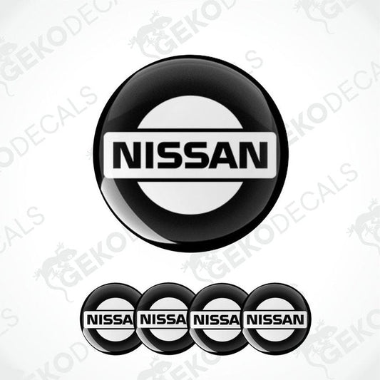 A set of four black, white NISSAN branded vinyl stickers with a polyurethane coating.