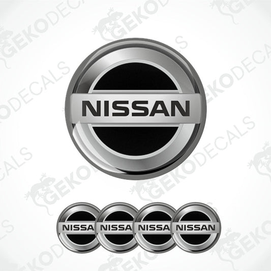 A set of four silver NISSAN branded vinyl stickers with a polyurethane coating.