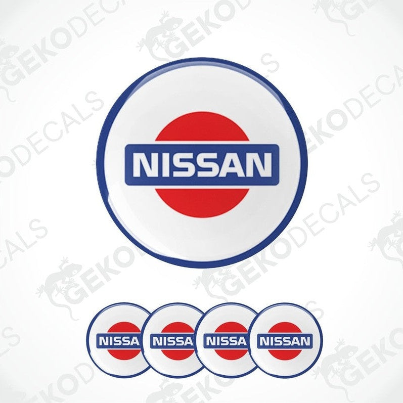 A set of four white vinyl stickers with the NISSAN brand logo in blue and red.
