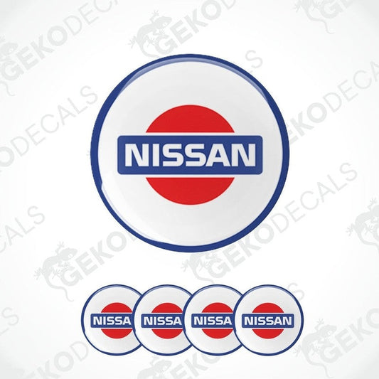A set of four white vinyl stickers with the NISSAN brand logo in blue and red.