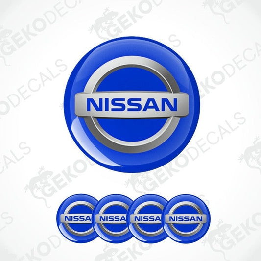 A set of four blue vinyl stickers with the NISSAN brand logo.