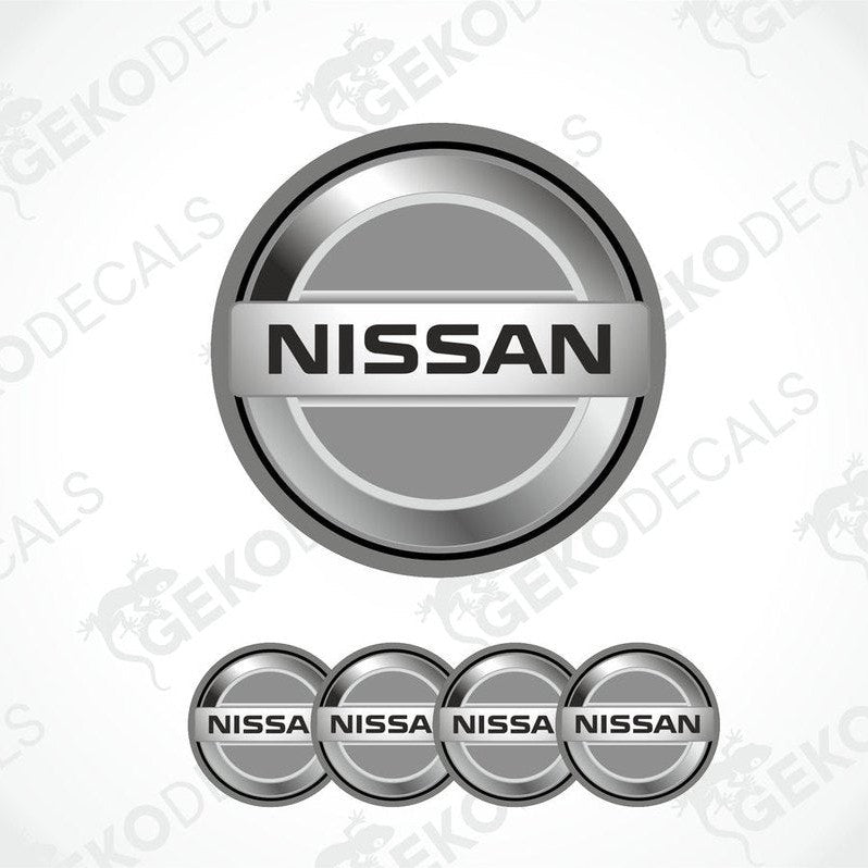 A set of four grey vinyl stickers with the NISSAN brand logo on them.