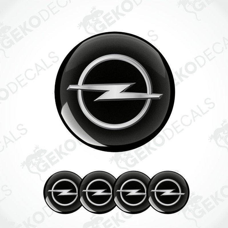 A set of black and silver OPEL brand vinyl decals with a polyurethane coating, including one larger decal and four smaller ones arranged in a row.