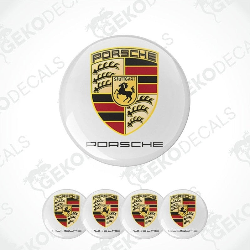 A set of four Porsche car wheel hub caps with the Porsche logo.