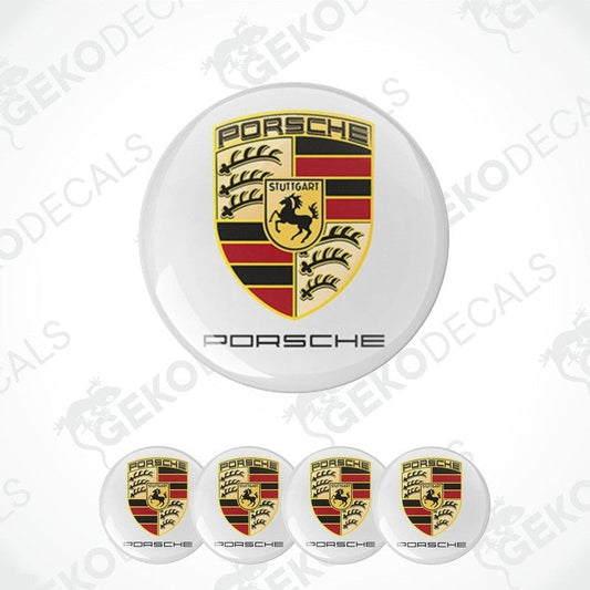 A set of four Porsche car wheel hub caps with the Porsche logo.