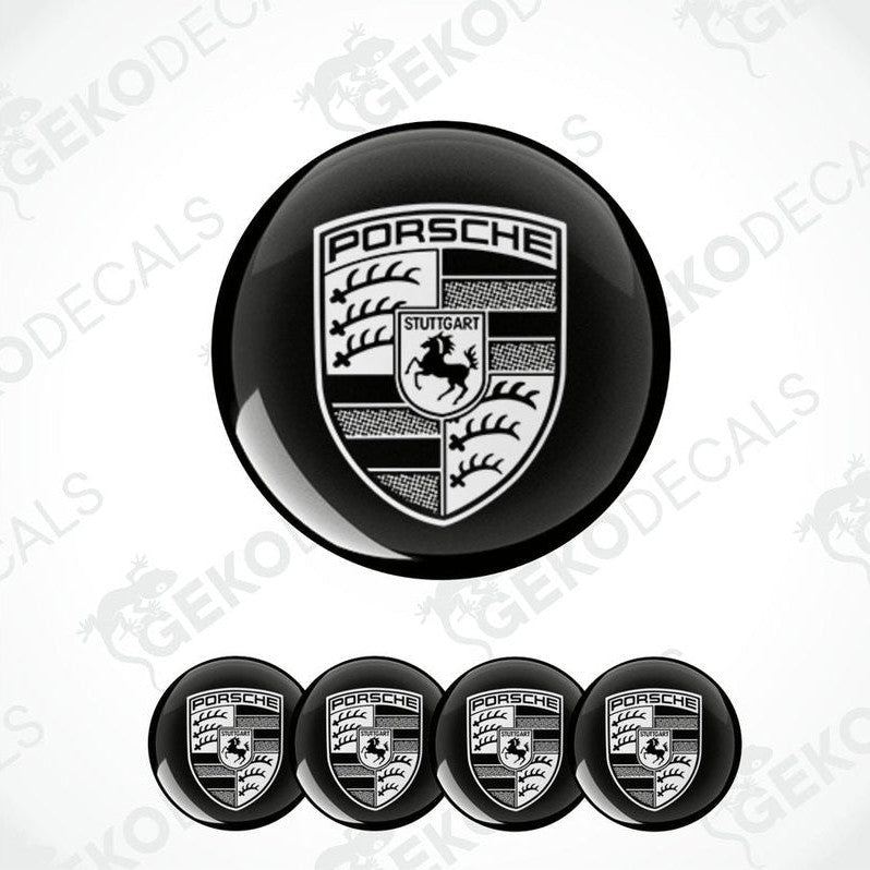 A set of black and white vinyl decals with the Porsche logo, including four dome-shaped stickers and one larger emblem.