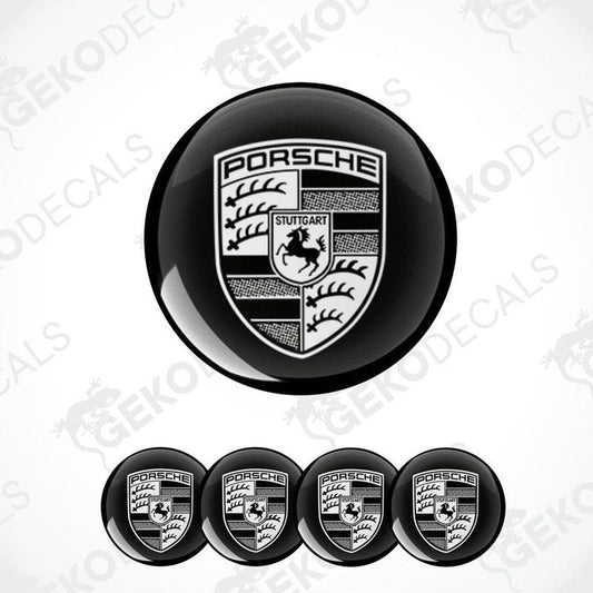 A set of black and white vinyl decals with the Porsche logo, including four dome-shaped stickers and one larger emblem.
