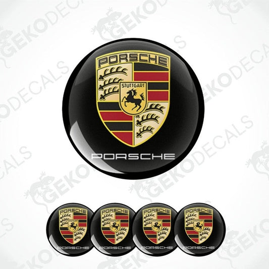 A set of four Porsche car wheel hub caps with the Porsche logo.