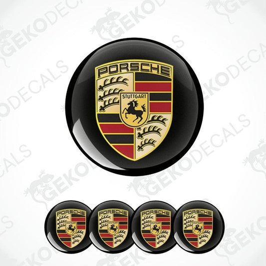 A set of four black, red, and gold Porsche branded vinyl stickers, with a dome shape and a polyurethane coating.