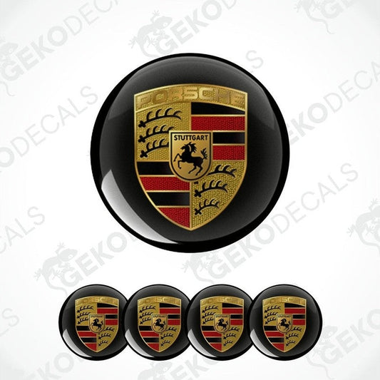 A set of four black, gold, red, and white vinyl stickers with a geometric pattern, featuring the Porsche brand logo.