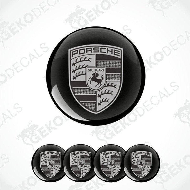 A set of four black and grey Porsche car wheel decals.
