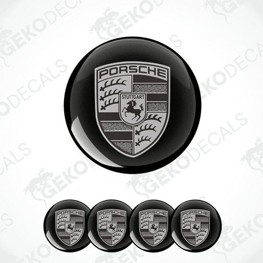 A set of four black and grey Porsche car wheel decals.