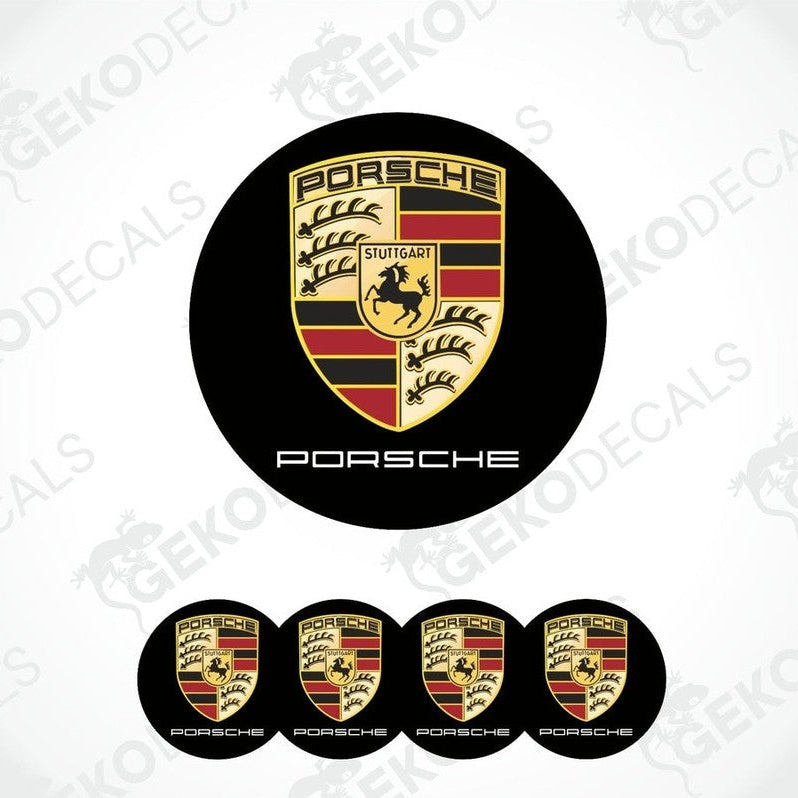 A set of four Porsche car wheel hub caps with the Porsche logo.