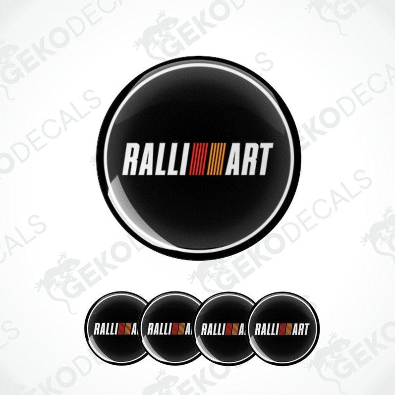 A set of four black vinyl stickers with the word 'RALLIART' and a geometric pattern in orange and red above the text.