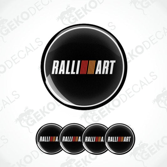 A set of four black vinyl stickers with the word 'RALLIART' and a geometric pattern in orange and red above the text.