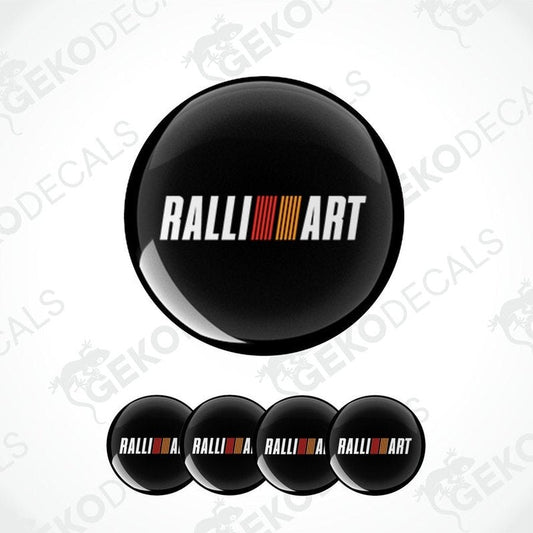 A set of four black vinyl stickers with the word 'RALLIART' printed in a colorful gradient design.