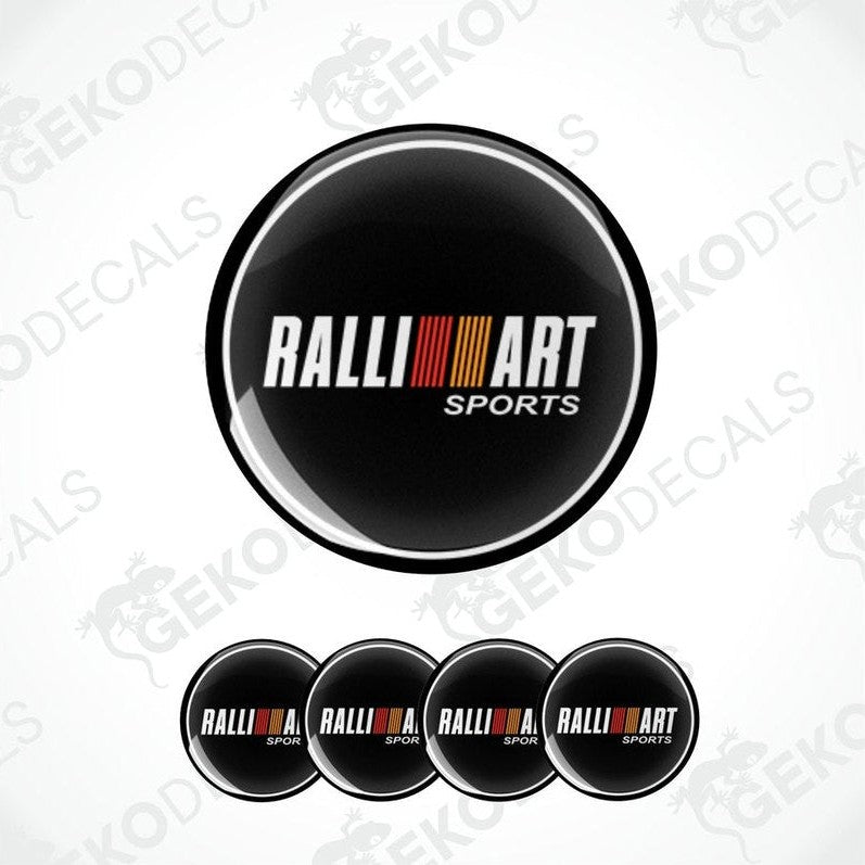 A set of four black round car decals with the 'RALLIART SPORTS' logo in white and red.