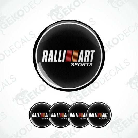 A set of four black round car decals with the 'RALLIART SPORTS' logo in white and red.
