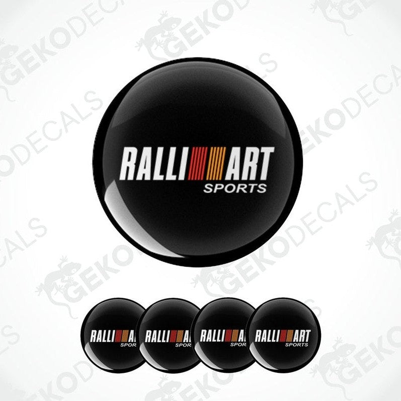 A set of four black round car decals with the 'RALLIART SPORTS' logo in white and red.