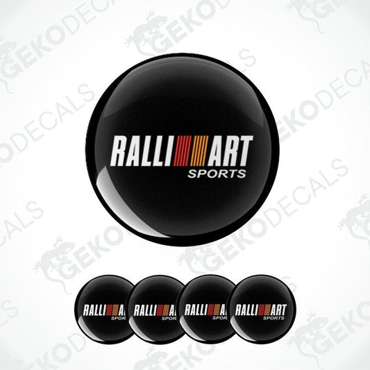 A set of four black round car decals with the 'RALLIART SPORTS' logo in white and red.