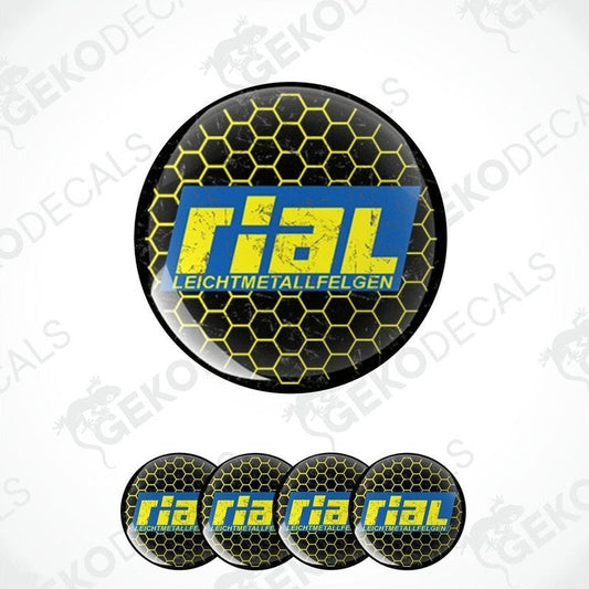 A set of four round vinyl stickers with a yellow and black design featuring the word 'RIAL' in bold letters, arranged on a white background.