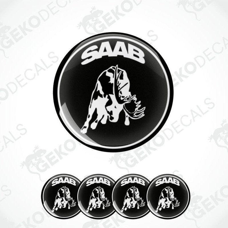 A set of black and white vinyl decals featuring a moose and the text 'SAAB'. The main decal is circular with the moose silhouette in white on a black background