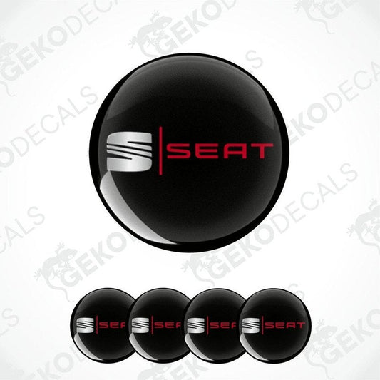 A set of four black vinyl decals with the 'SEAT' logo in silver and red color.