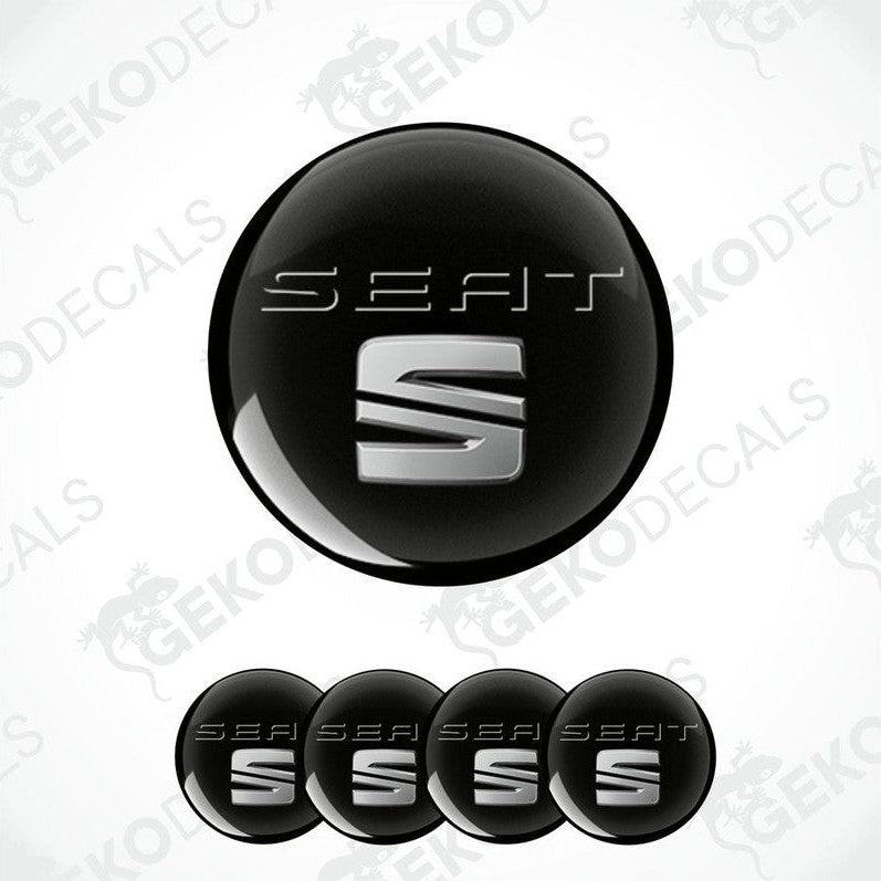 A set of four black vinyl decals with the SEAT logo in white, intended for use as car wheel caps.