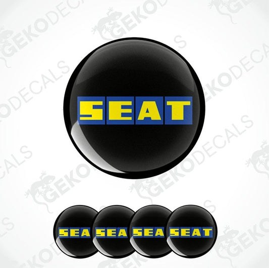 A set of four black vinyl stickers with the word 'SEAT' and a blue and yellow logo pattern on them.