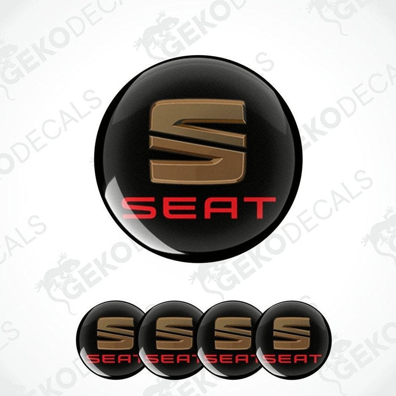 A set of four black vinyl stickers with the word 'SEAT' printed in red and chrome brown colors.