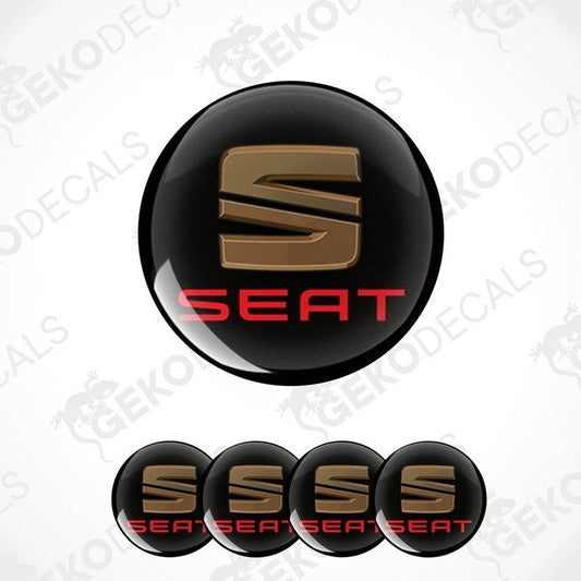 A set of four black vinyl stickers with the word 'SEAT' printed in red and chrome brown colors.