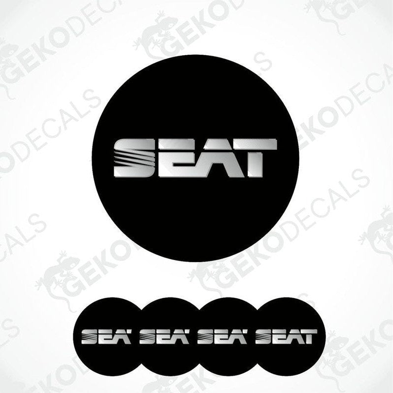 

A set of round car stickers with the brand name "SEAT" written in silver in block letters, mainly in black with a glossy finish.