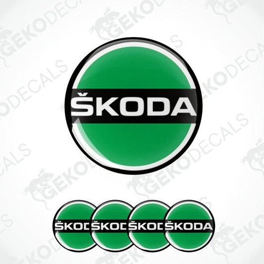 A set of green, black, and white Škoda branded vinyl decals designed for use on car wheels.