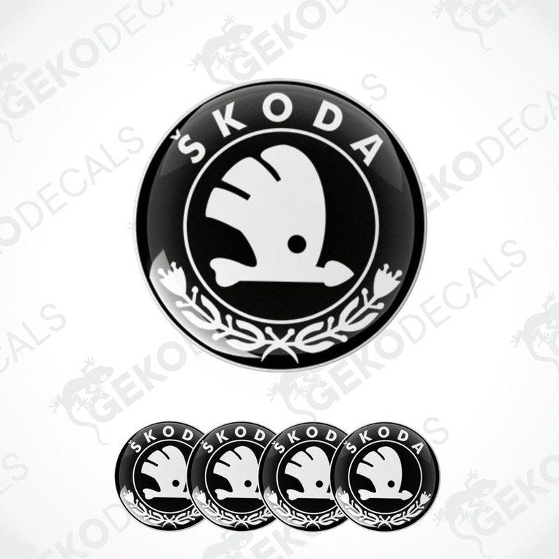 A set of four black, white, and gray vinyl stickers with a ŠKODA logo design, displayed on a white background.