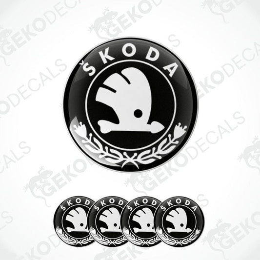 A set of four black, white, and gray vinyl stickers with a ŠKODA logo design, displayed on a white background.