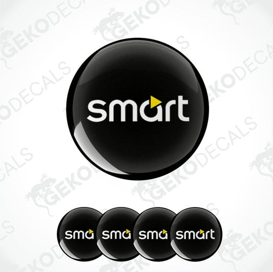 A set of four round car decals with the smart car logo in black, yellow, and white colors.