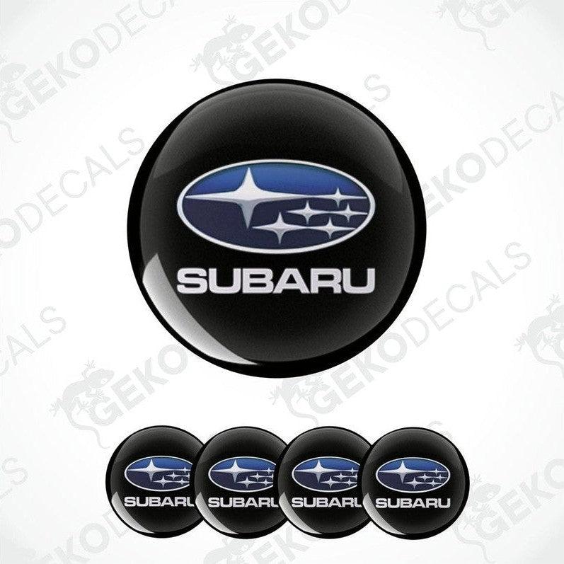 A set of four black vinyl stickers with the Subaru brand logo on them.